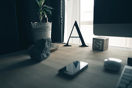 black iPhone on brown table thumbnail