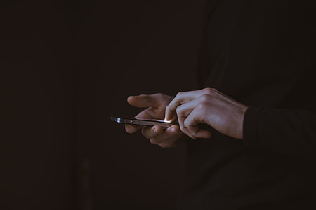 person using black iPhone 4 thumbnail