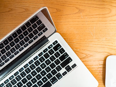 MacBook Pro on brown wooden surface thumbnail