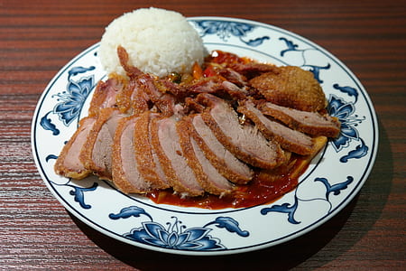 sliced fried meat with cup of rice in white and blue plate thumbnail