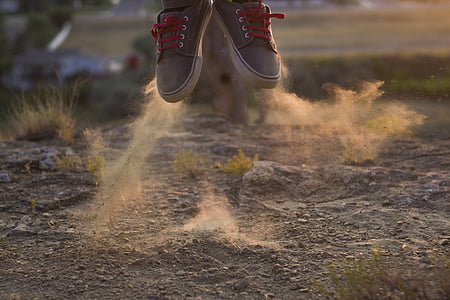 person wearing gray low-top sneakers thumbnail