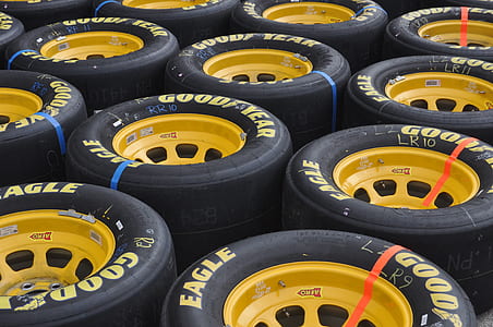 close-up photography of yellow multi-spoke vehicle wheel and GoodYear tire lot thumbnail