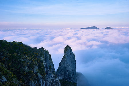 gray and green mountain surrounded by white clouds during daytime thumbnail