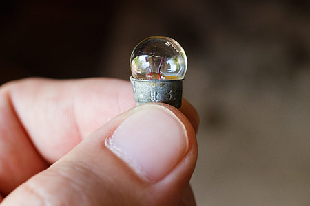 selective focus photography of person holding clear glass dome thumbnail