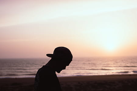 Silhouette of Man Wearing Cap at the Beach thumbnail