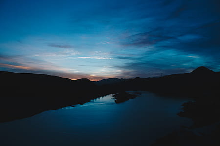 silhouette mountains under gray sky thumbnail