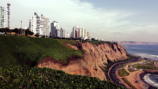 white high rise buildings and gray road at daytime thumbnail