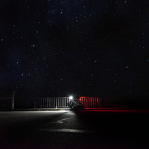 bicycle near handrails under starry sky thumbnail