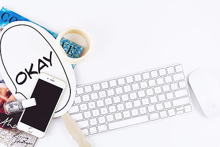 flat lay photo of silver iPhone 6 near gray nail polish and wireless Apple keyboard and Apple Magic mouse thumbnail