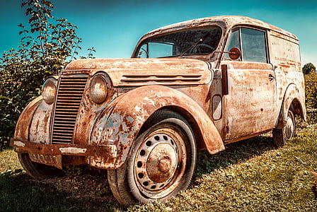 photo of rusty vintage white car on green grass thumbnail
