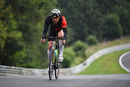 man riding bicycle on road thumbnail