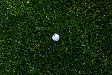 golf ball on green grass field thumbnail