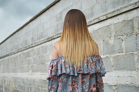 woman beside gray concrete wall thumbnail