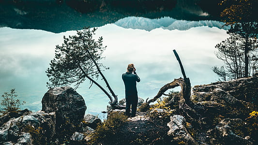 man taking photo on hill thumbnail