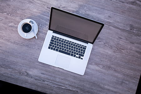 MacBook beside white coffee cup thumbnail