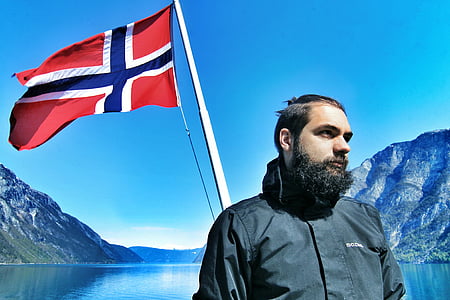 man standing near red and blue flag thumbnail