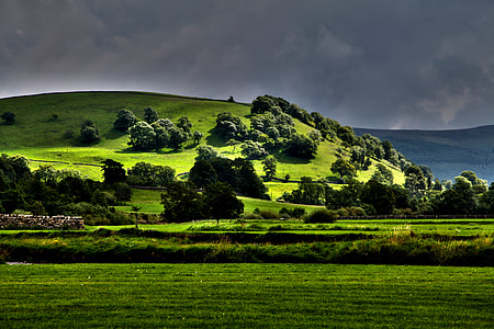landscape photography of green hills and trees thumbnail