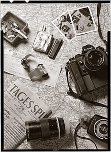 black Nikon DSLR camera with lens and film thumbnail