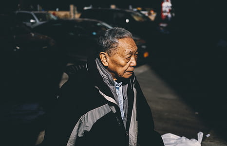 man in black zip-up jacket in front of the car thumbnail