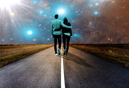 man and woman holding each other's arm walking towards road thumbnail