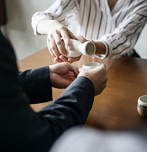 person pouring water on white cup thumbnail