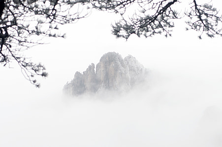 brown mountain covered by clouds thumbnail