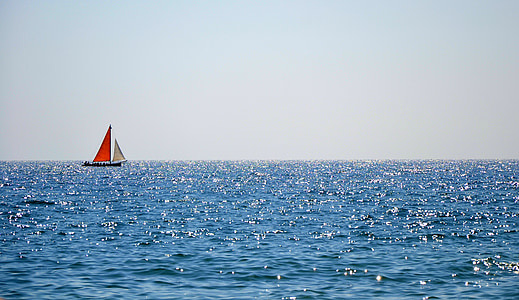 red and white sailing boat on body of water photography thumbnail