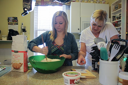 woman wearing blue dress shirt beside woman wearing white t-shirt inside house thumbnail