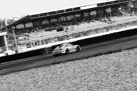 grayscale photography of racing coupe on road thumbnail