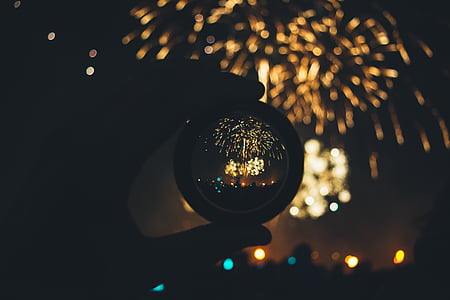 person holding ball with firecrackers reflection thumbnail