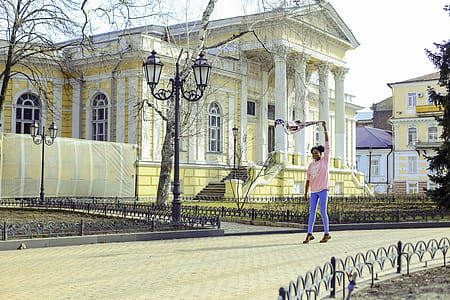 Girl Wearing Pink Long-sleeved Shirt and Blue Pants at Street thumbnail
