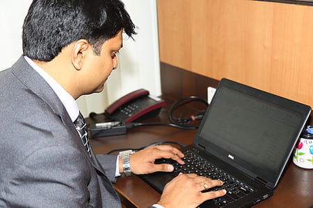 man sitting in front of laptop computer thumbnail