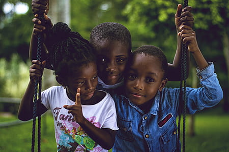 three children sitting on swing thumbnail