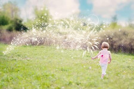 toddler in pink walking on the grass thumbnail