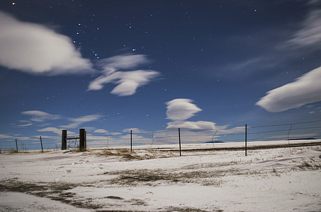 black steel fence under white clouds thumbnail