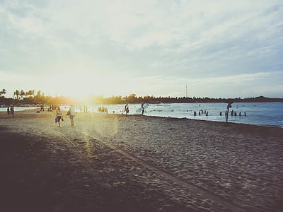 people on body of water and shore during daytime thumbnail