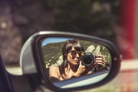 person taking selfie on side mirror thumbnail