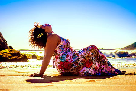 woman lying on brown sand near beach thumbnail