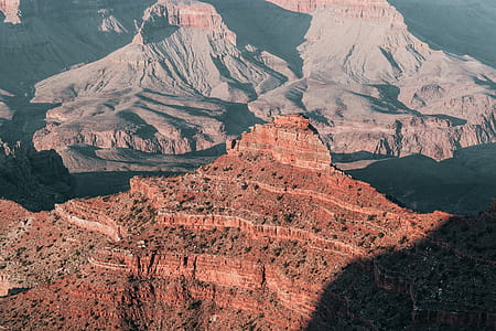 Crumbling red peak of grand canyon in sunlight and long shadows thumbnail