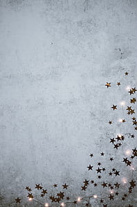 clear string lights and gold star cutouts decorated wall thumbnail