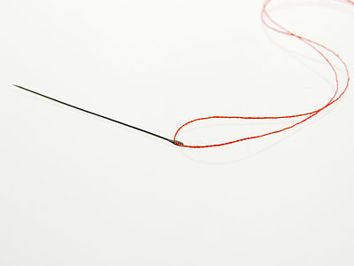 gray needle with red thread thumbnail