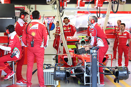 people standing near Ferrari F1 inside room thumbnail
