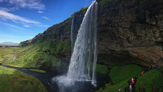 photo of group of person near waterfalls thumbnail