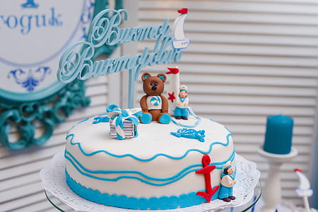 white and blue bear-themed cake inside room thumbnail