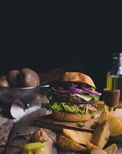 burger with slice red onions, tomatoes, patties and lettuce thumbnail