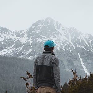 person standing in front of mountain thumbnail