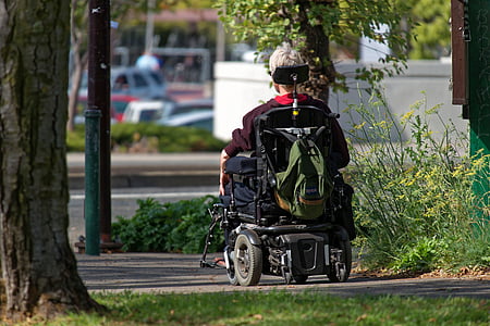 person on wheelchair at sidewalk thumbnail