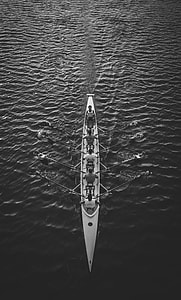 grayscale photo of group of people riding boat thumbnail