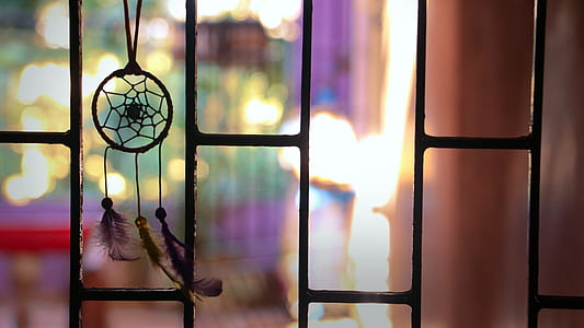 photo of dream catcher near window grille thumbnail
