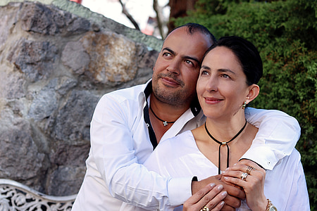 man and woman wearing white dress shirts sitting near boulder thumbnail